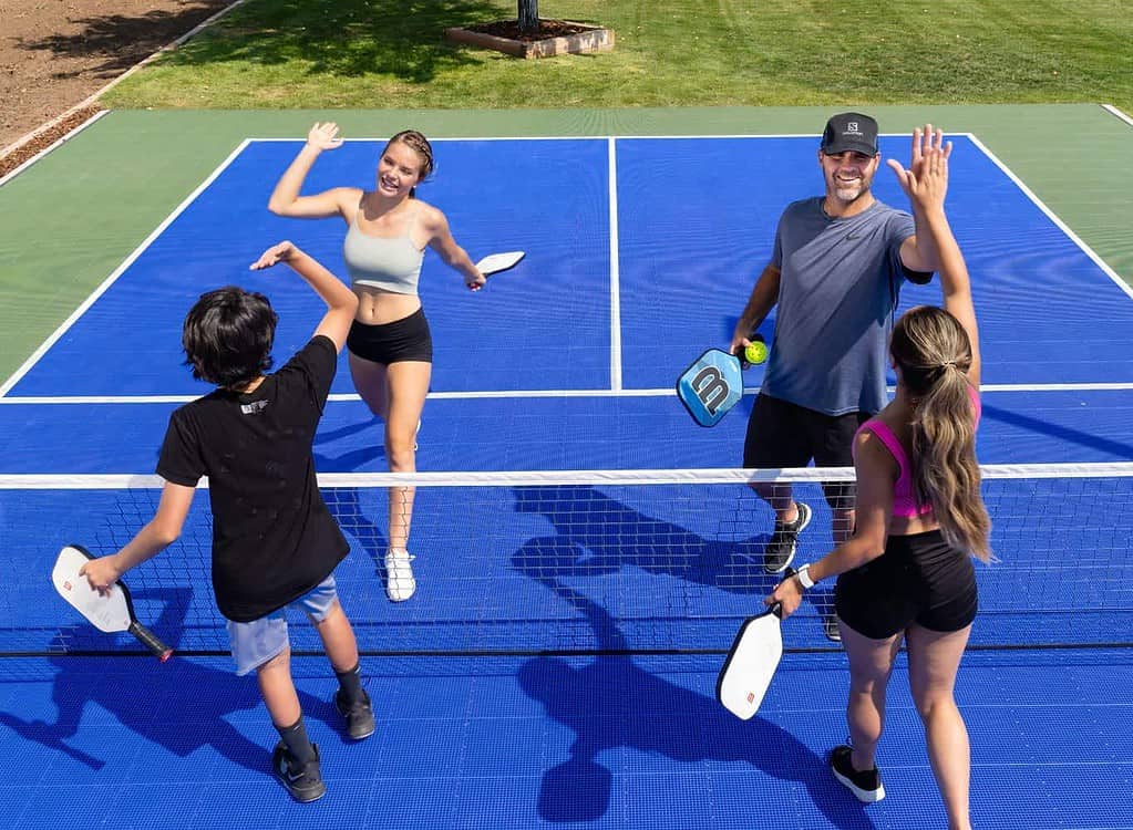 backyard pickleball court family playing